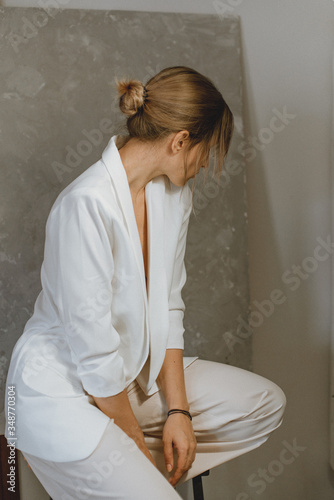 Sensual portrait of a young attractive woman in a white blazer.