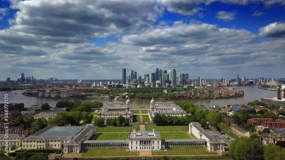 Outstanding aerial view of Isle of Dogs and financial district Canary Wharf in London United Kingdom in a scattered cloudy day under blue sky from Greenwich University and Observatory Outstanding aerial view of Isle of Dogs and financial district Canary Wharf in London United Kingdom in a scattered cloudy day under blue sky from Greenwich University and Observatory