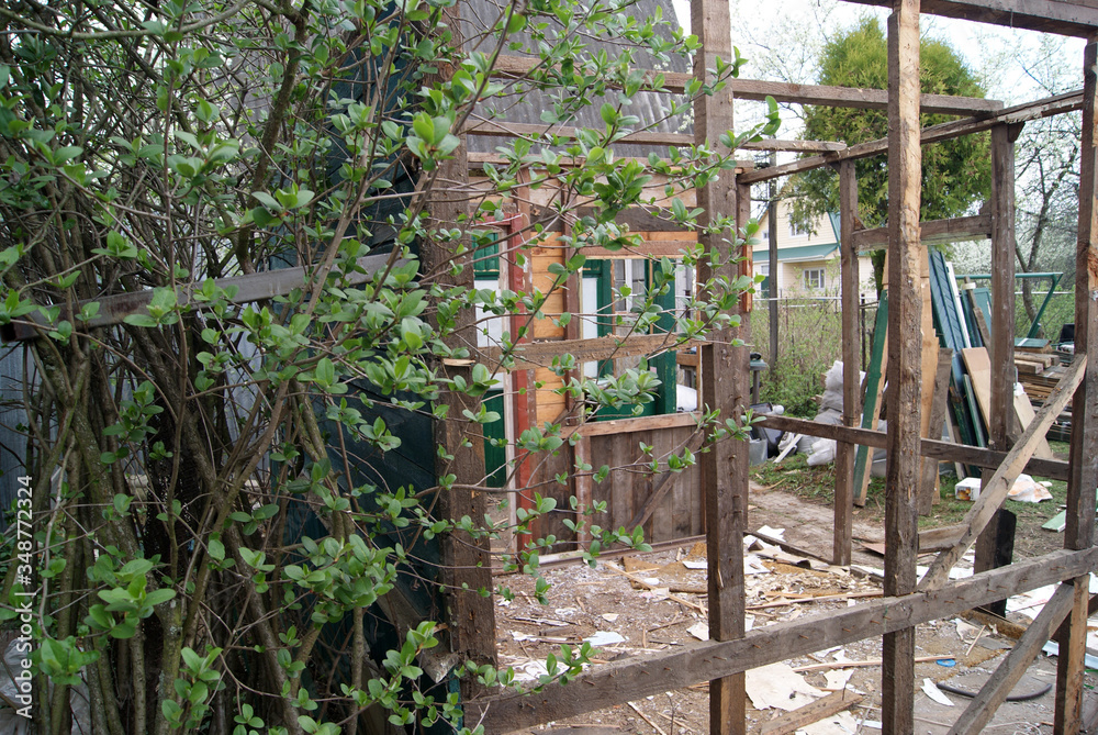 Dismantling of an old wooden summer house in the country. Wooden frame Dismantling of an old wooden summer house in the country. Wooden frame