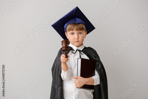 Portrait of little judge on grey background photo