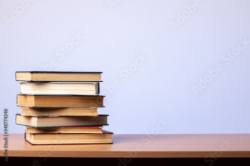 Stack of books on the table on a blue background. learning concept. literature.