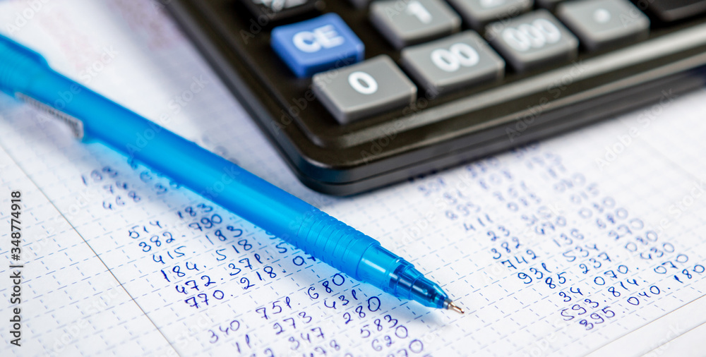 Pen and calculator. Background Items for doing business in the office in the composition. Pen and calculator. Background Items for doing business in the office in the composition.
