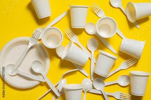 Bild auf Leinwand Many sets of biodegradable disposable tableware on a  yellow  background