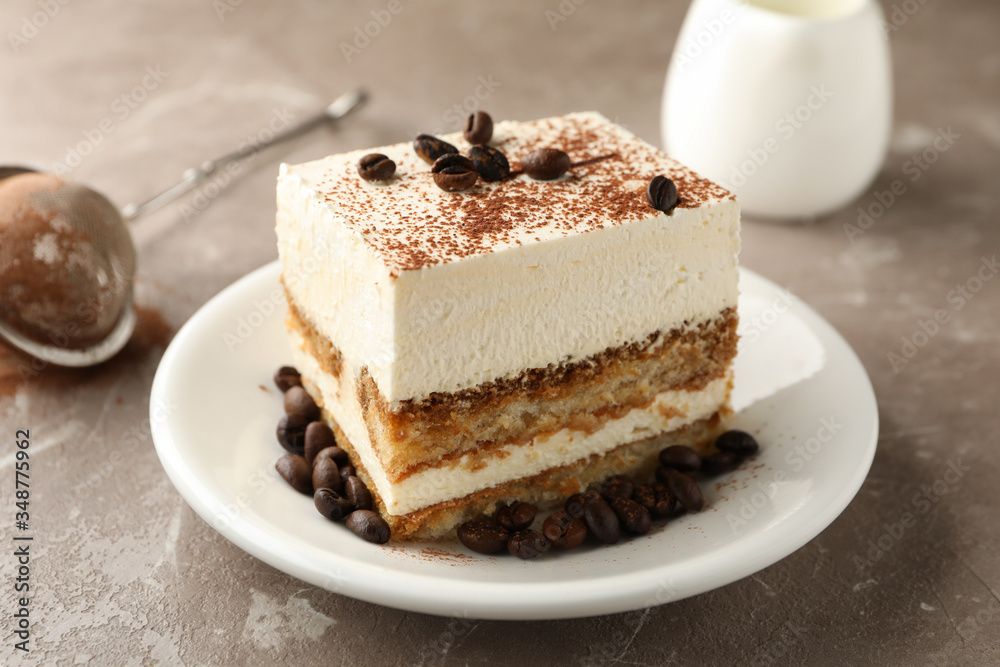 Composition with plate of tiramisu on light brown background. Tasty dessert Composition with plate of tiramisu on light brown background. Tasty dessert