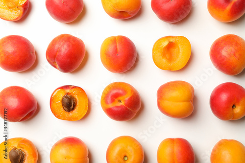 Flat lay with tasty apricots on white background, top view