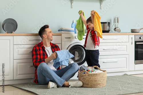 Man and his little son doin...