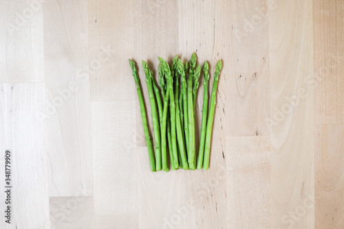 fresh green asparagus on wooden background  top view