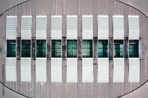 Aerial view of the roof, lines of Solar panels, glass, window, warehouse