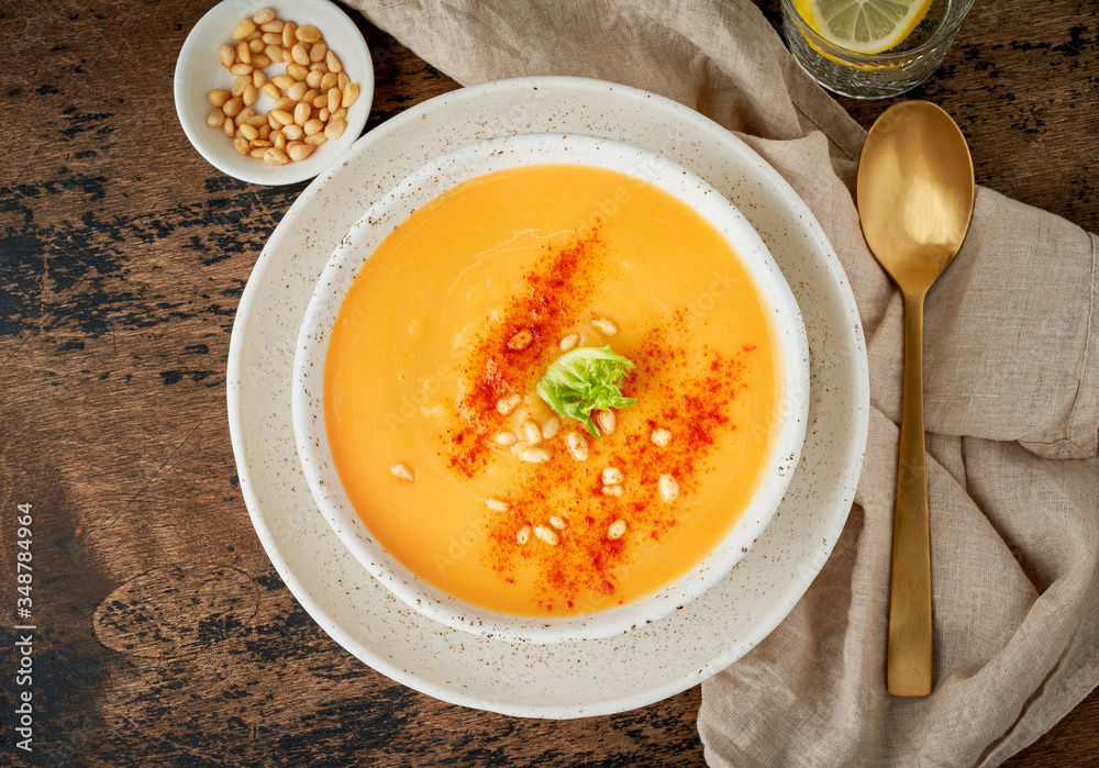 Autumn pumpkin soup with smoked paprika, pine nuts, vegetarian dish Autumn pumpkin soup with smoked paprika, pine nuts, vegetarian dish