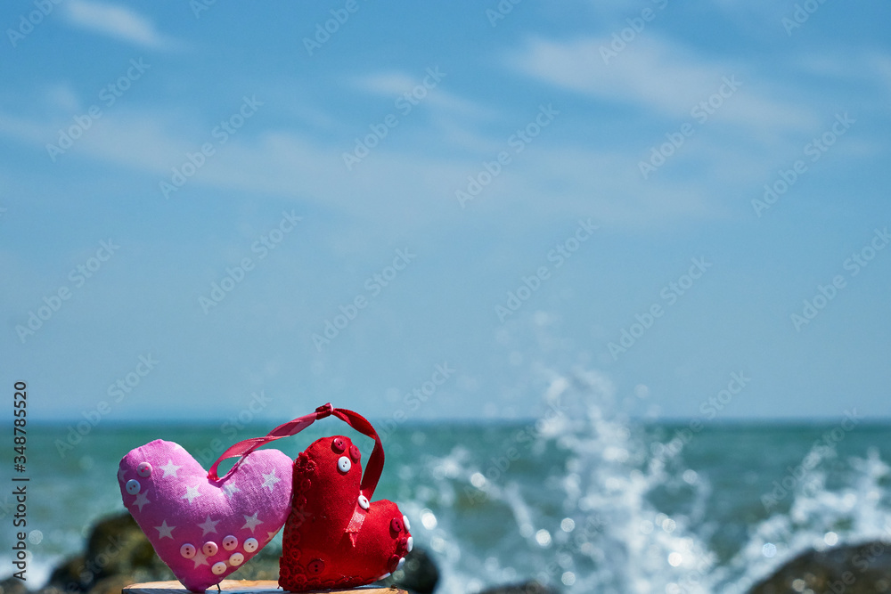 Red hearts. Soft toy. Handwork. Sea shore. Waves hit the stones. Red hearts. Soft toy. Handwork. Sea shore. Waves hit the stones.