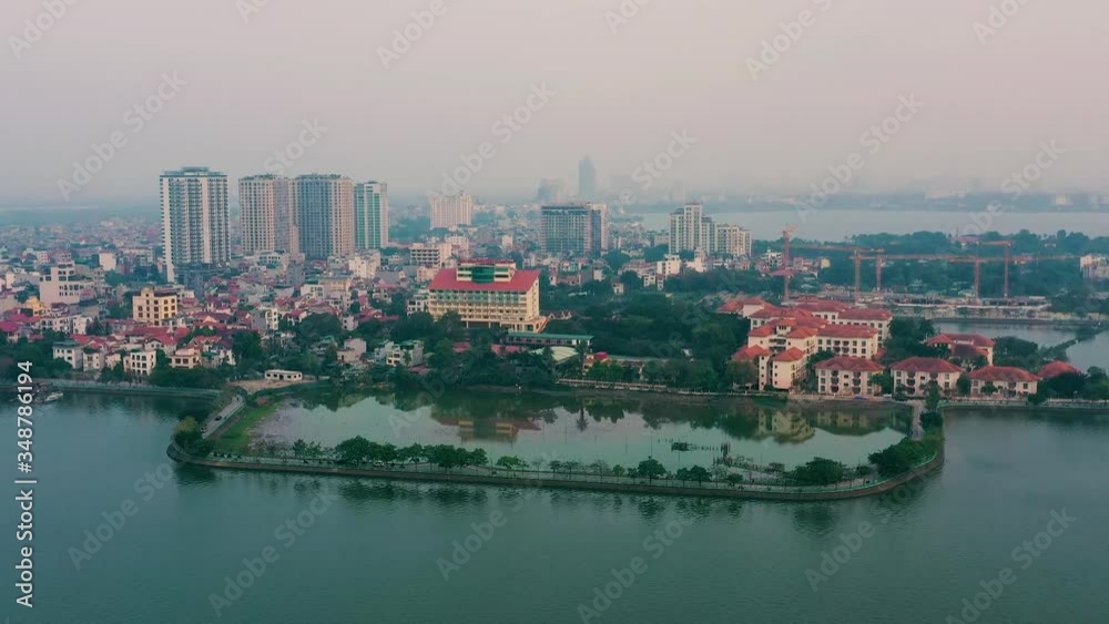 HANOI, VIETNAM - APRIL, 2020: Aerial panorama view of the roofs of houses of one of the districts near lake in Hanoi. HANOI, VIETNAM - APRIL, 2020: Aerial panorama view of the roofs of houses of one of the districts near lake in Hanoi.