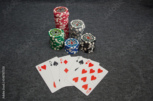 playing cards and poker chips on grey background