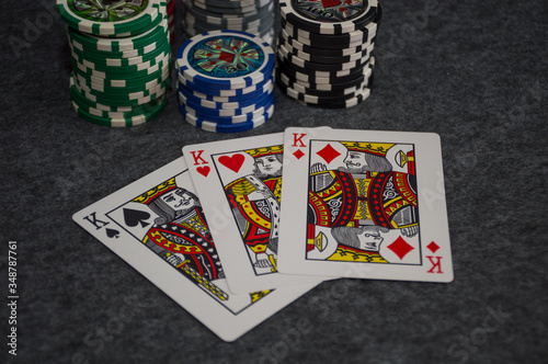 playing cards and poker chips on grey background