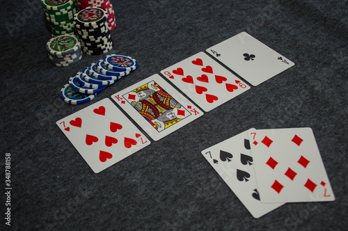 playing cards and poker chips on grey background