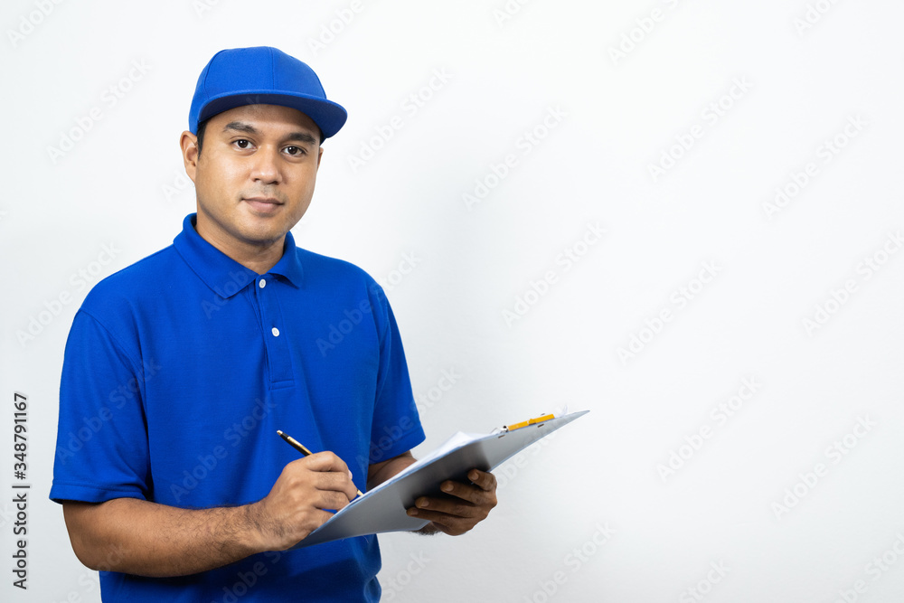 Asian Delivery man signing clipboard receipt of delivery package on isolated white background. Asian Delivery man signing clipboard receipt of delivery package on isolated white background.