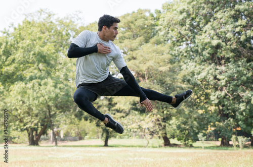 Young handsome sport man jumping training outdoors healthy lifestyle and sport concept.