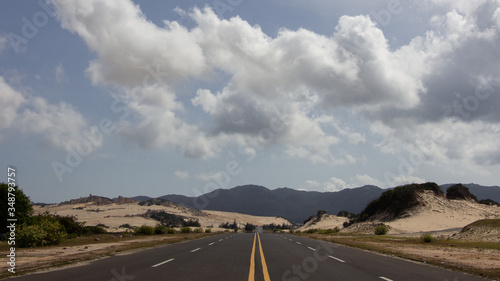 Empty highway between the dunes
