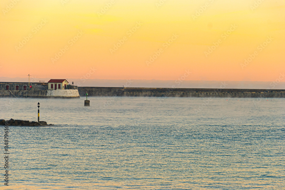 Golden sunrise in the small port hut, Socoa, Saint Jean de Luz, Basque country, France Golden sunrise in the small port hut, Socoa, Saint Jean de Luz, Basque country, France