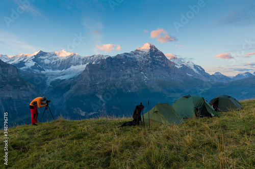 Alpine valley glowing by sunlight. Popular tourist attraction. Dramatic and picturesque scene with tents. Location place in Swiss alps, Grindelwald, Bernese Oberland, Europe. Beauty world. Eiger