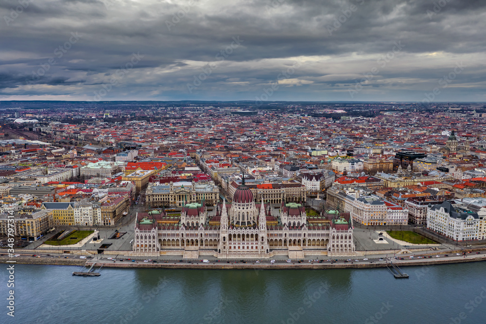 Budapest, Hungary - Aerial panoramic drone view of the beautiful Hungarian Parliament building with Puskas Arena at background and cloudy dramatic sky above