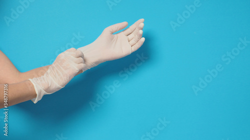 Two hand wearing white gloves and right hand is pulling.Put on blue background.