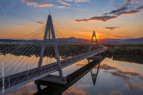 Budapest  Hungary - Aerial view of Megyeri suspension bridge at sunset with beautiful blue and golden sky and clouds