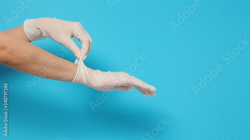 Two hand wearing white gloves and right hand is pulling.Put on blue background.