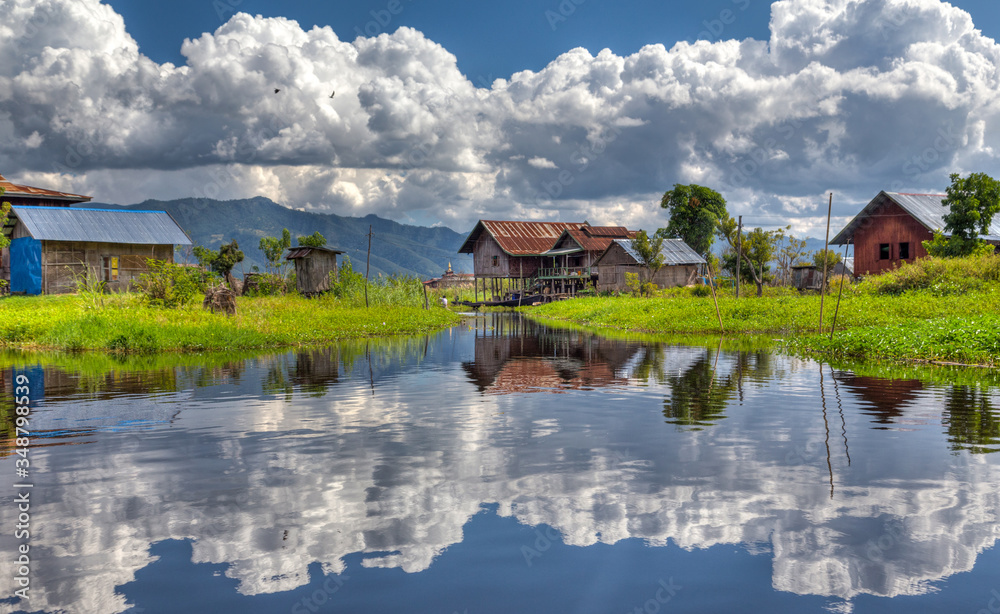 Fototapeta premium Dramatic Clouds Reflection with a farmer house in Inle Lake Myanmar