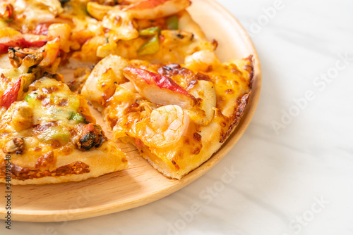 seafood pizza on wood tray