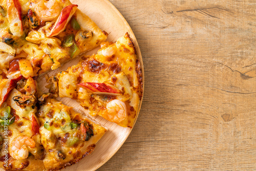 seafood pizza on wood tray