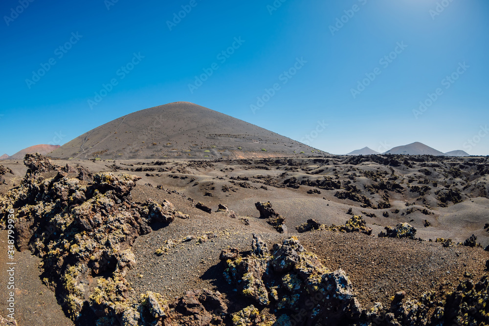 Volcanic landscape with volcano, stones and rocks at Lanzarote in Spain.