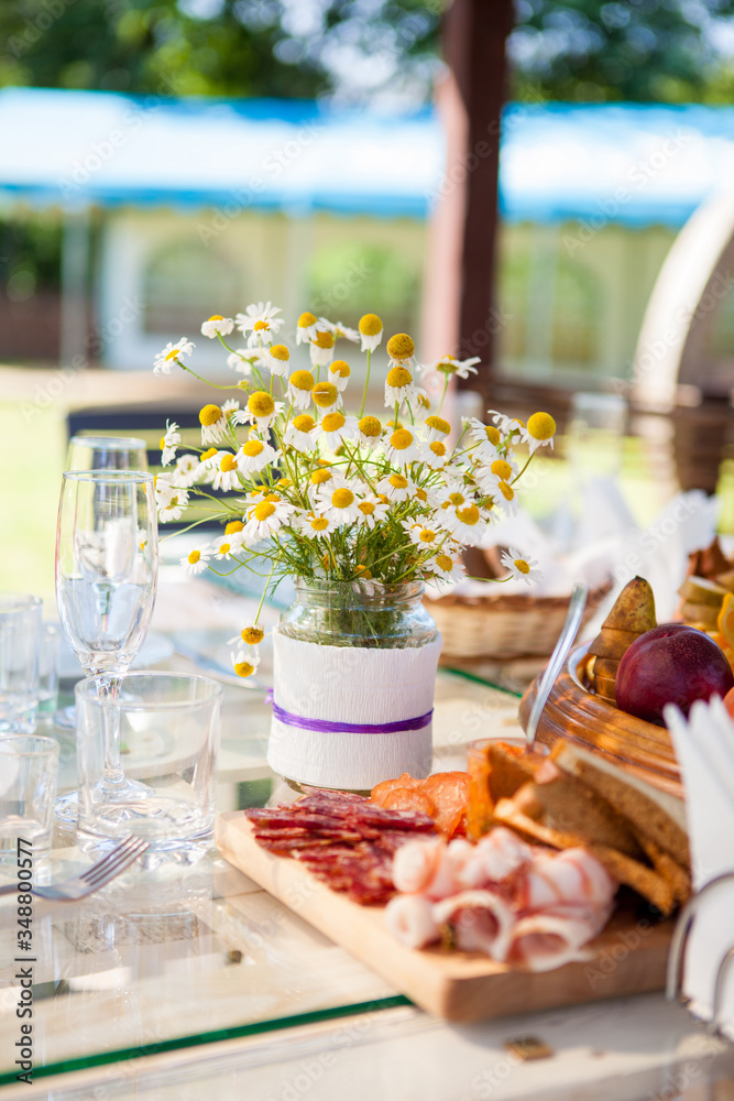 table set dishes and decorated with an armful of daisies table set dishes and decorated with an armful of daisies