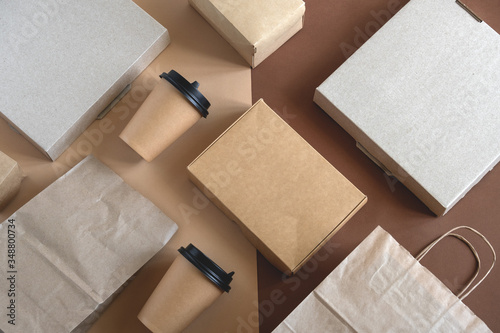 top view flat lay disposable blank delivery food packaging on a beige and brown background photo