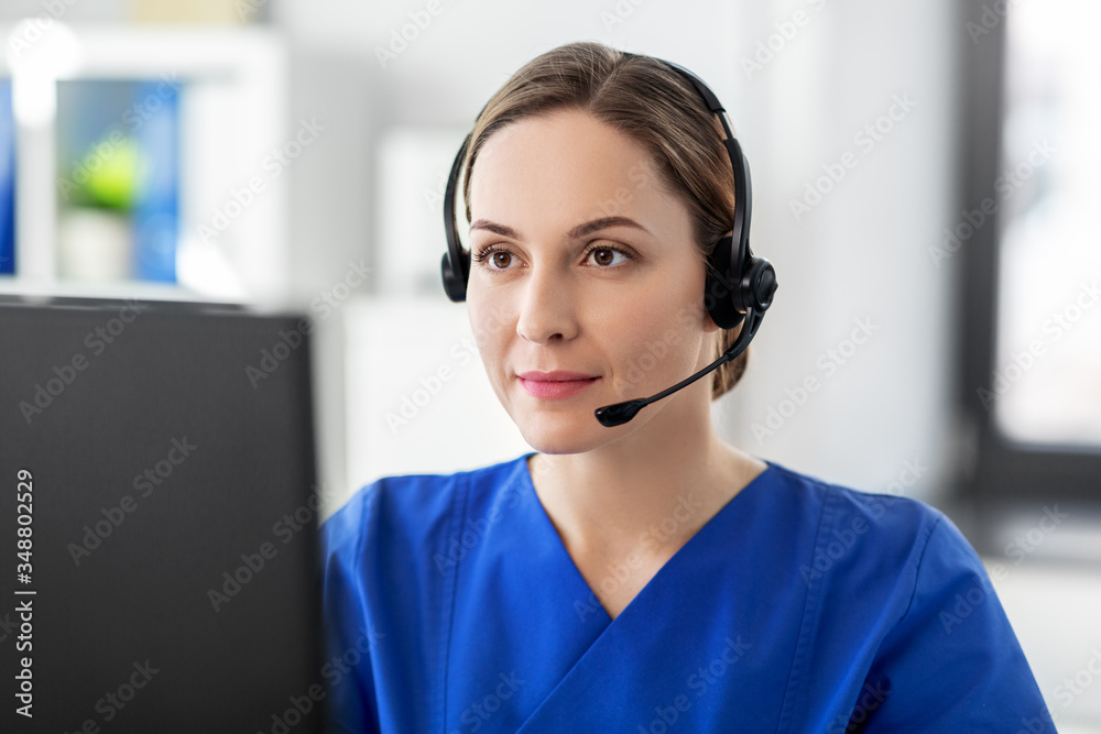 medicine, technology and healthcare concept - female doctor or nurse with headset and computer working at hospital medicine, technology and healthcare concept - female doctor or nurse with headset and computer working at hospital