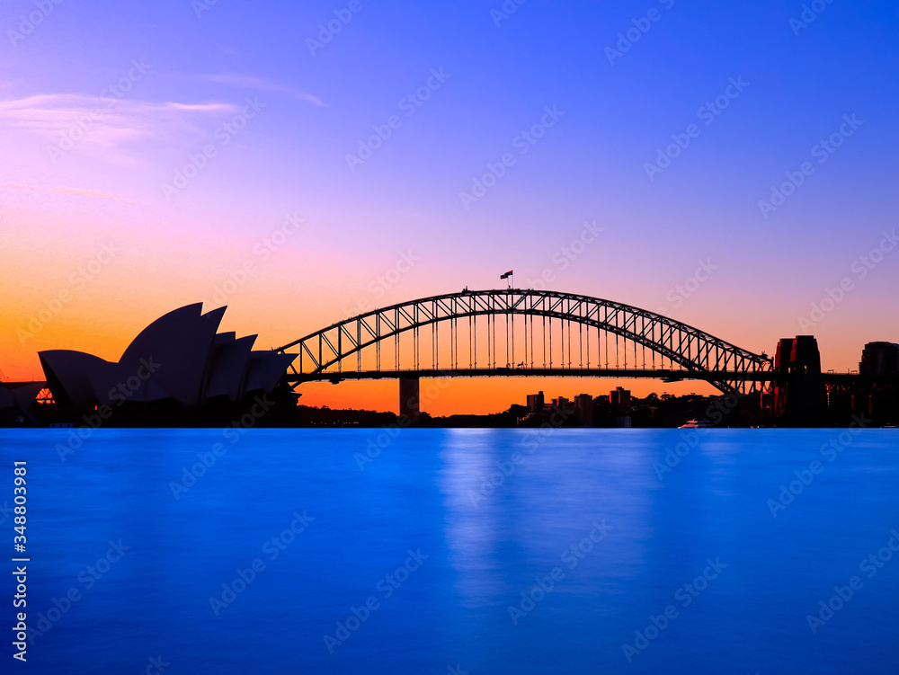 Panoramic view of Sydney Harbour with all the vibrant colours on a orange and blue sunset afternoon Panoramic view of Sydney Harbour with all the vibrant colours on a orange and blue sunset afternoon