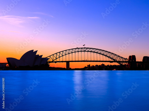 Panoramic view of Sydney Harbour with all the vibrant colours on a orange and blue sunset afternoon  © Elias Bitar