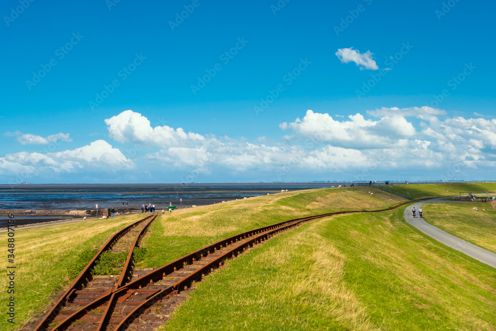 Dike by Luettmoorsiel with rails of the Hallig Railway, also called Lorenbahn Dike by Luettmoorsiel with rails of the Hallig Railway, also called Lorenbahn