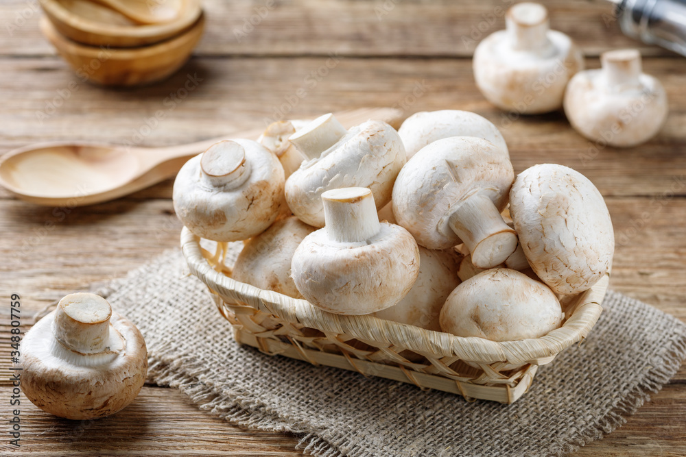 Fresh mushrooms champignon mushrooms on a wooden table. Fresh mushrooms champignon mushrooms on a wooden table.