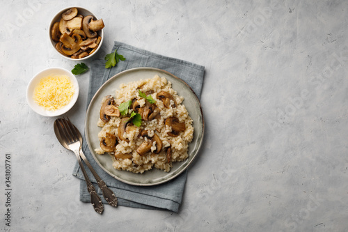 A dish of Italian cuisine - risotto from rice and mushrooms. Top view. Flat lay. Copy space.