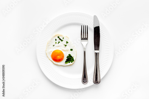 Fried eggs on plate - white kitchen table top view