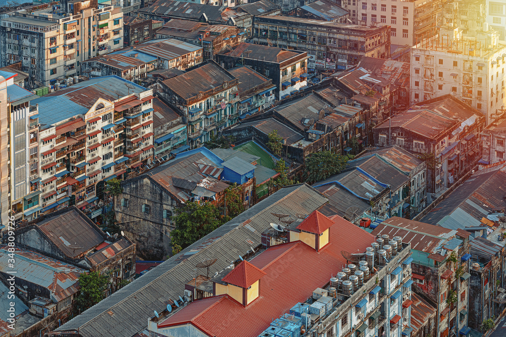 01/22/2020 Yangon, Myanmar (Burma), Aerial shot, view from the drone on the downtovn of Yangon with tiled and moss-covered houses at sunset pop colors. Yangon - the ancient capital of Burma