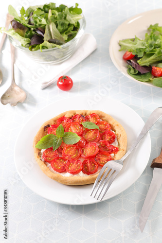 plate of tomato quiche with salad