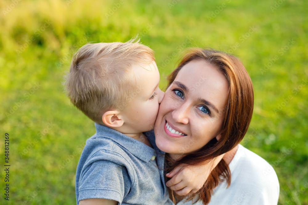 Enjoying life together concept. Happy mother and son having fun outdoors on a sunny summer day. mom and son have fun together. Mother's Day. Enjoying life together concept. Happy mother and son having fun outdoors on a sunny summer day. mom and son have fun together. Mother's Day.