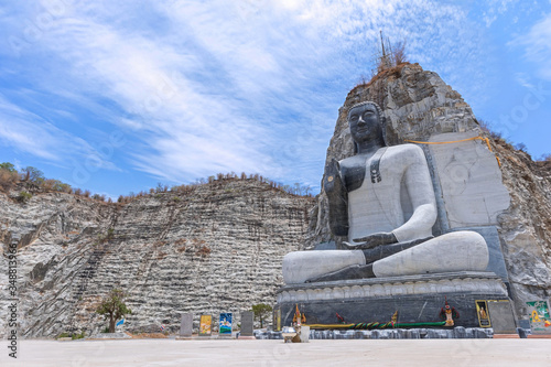 Stone Buddha statue at Wat Khao Tham Thiam, Suphanburi, Thailand. photo