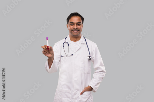 Indian Man Doctor Holding Blood Tube Analysis. Science, Medical Concept. Isolated