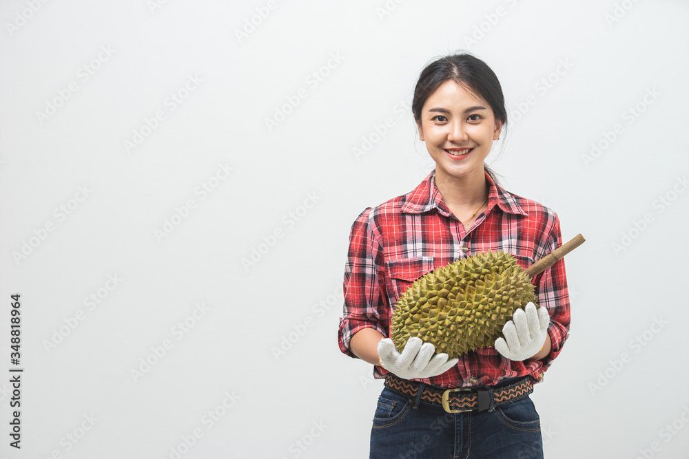 Portrait Asian young woman she smiling and holding durian fruit. Female farmer happy holding durian fruit in studio white background. Portrait Asian young woman she smiling and holding durian fruit. Female farmer happy holding durian fruit in studio white background.