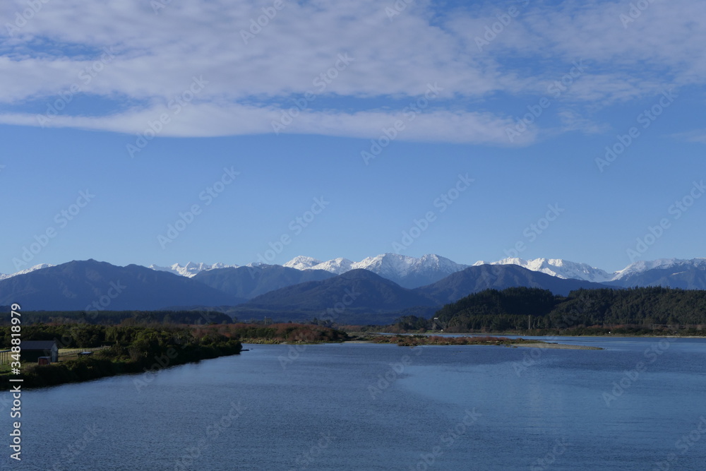 Stream in New Zealand West Coast, Hokitika River with Southern Alps