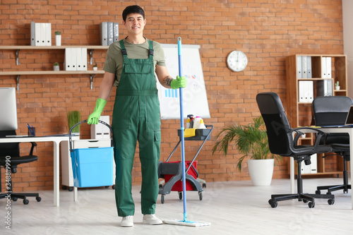 Portrait of male Asian janitor in office