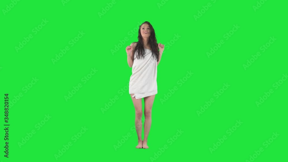 Slow motion of young happy carefree woman dancing in bathroom wrapped in towel. Full body pre keyed on green screen chroma key background Slow motion of young happy carefree woman dancing in bathroom wrapped in towel. Full body pre keyed on green screen chroma key background