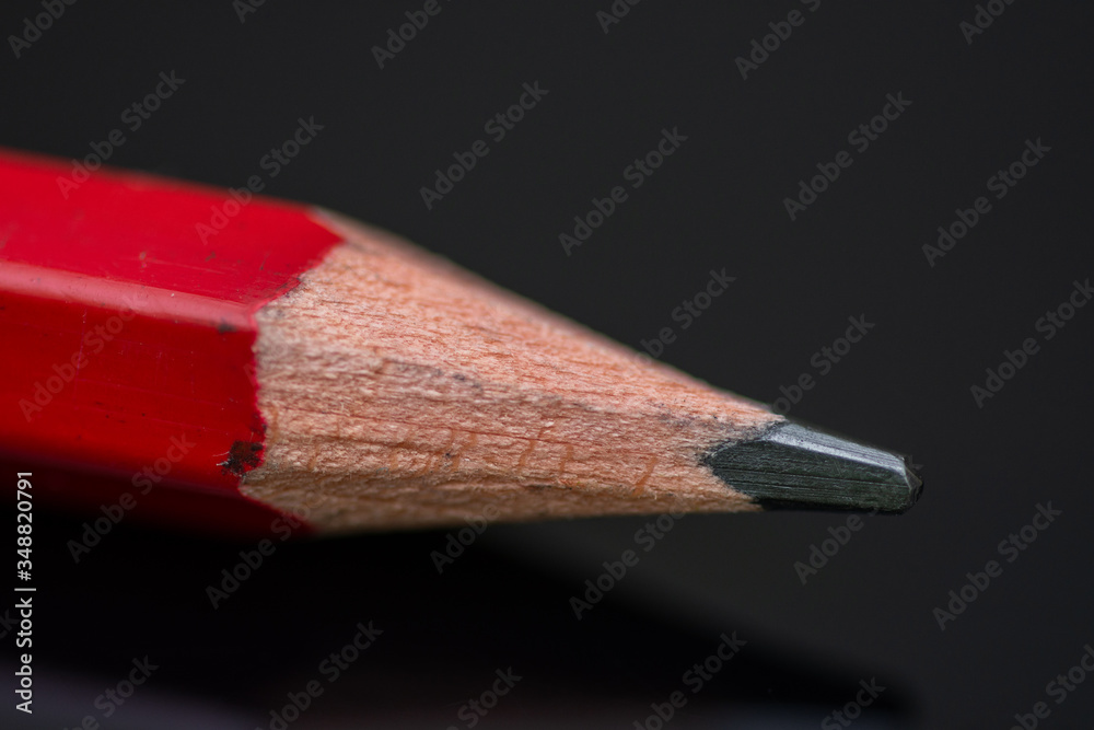 Obraz premium Red pencil in high resolution isolated on black background ,Isolated graphite pencil